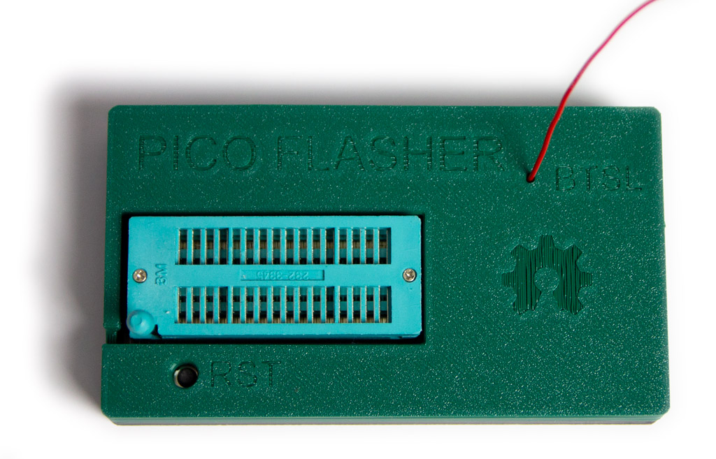 Insert a thin wire or a paperclip into the BTSL hole and press down to enable the flash procedure upon connection.